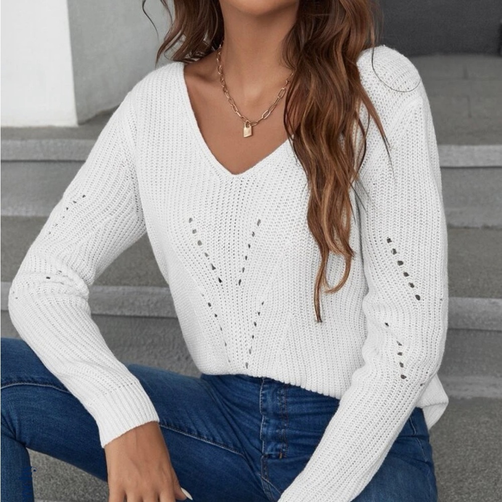 White long sleeved sweater with bow ties on the back